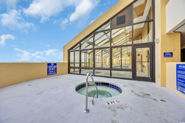 view of swimming pool featuring a hot tub