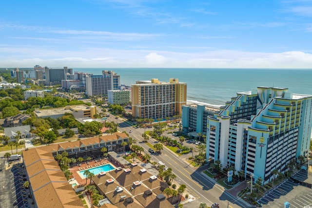 view of urban area with a pool and a nearby body of water