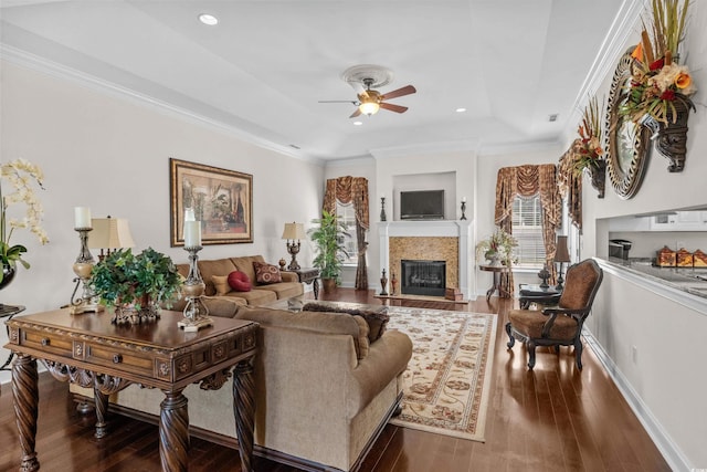 5628 Marion Cir, Myrtle Beach, SC 29577 - living room with ceiling fan, a fireplace with flush hearth, a raised ceiling, wood-type flooring, and ornamental molding