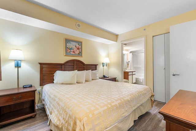 1604 N Ocean Blvd Unit 904, Myrtle Beach, SC 29577 - bedroom with connected bathroom and wood finished floors