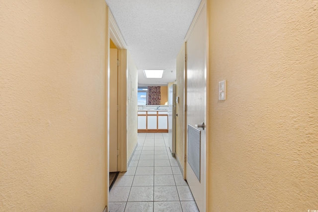 1604 N Ocean Blvd Unit 904, Myrtle Beach, SC 29577 - corridor featuring a textured ceiling, a textured wall, and light tile patterned floors
