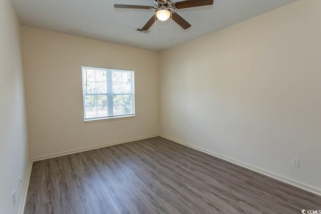unfurnished room featuring baseboards, a ceiling fan, and wood finished floors
