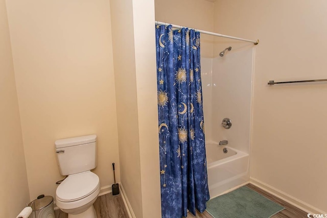 full bathroom featuring toilet, baseboards, wood finished floors, and shower / tub combo