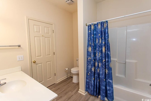 full bath with a sink, toilet, shower / bath combination with curtain, wood finished floors, and visible vents