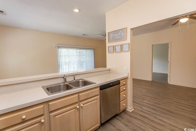 kitchen with a sink, light countertops, ceiling fan, and stainless steel dishwasher