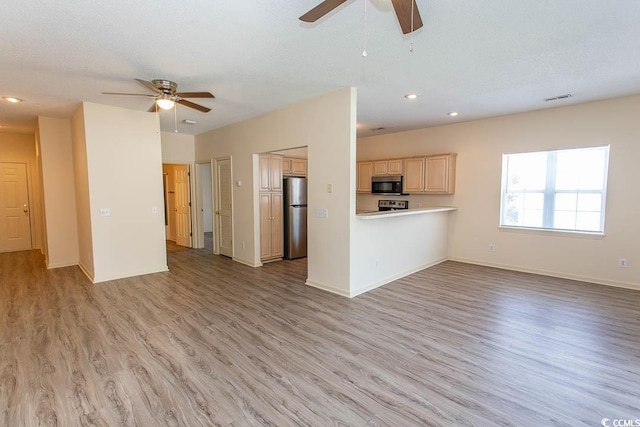 unfurnished living room with baseboards, a ceiling fan, light wood-style flooring, and recessed lighting