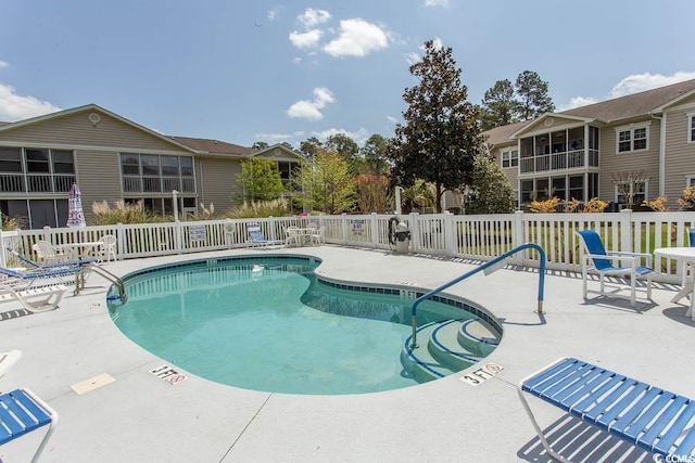 pool with fence and a patio area