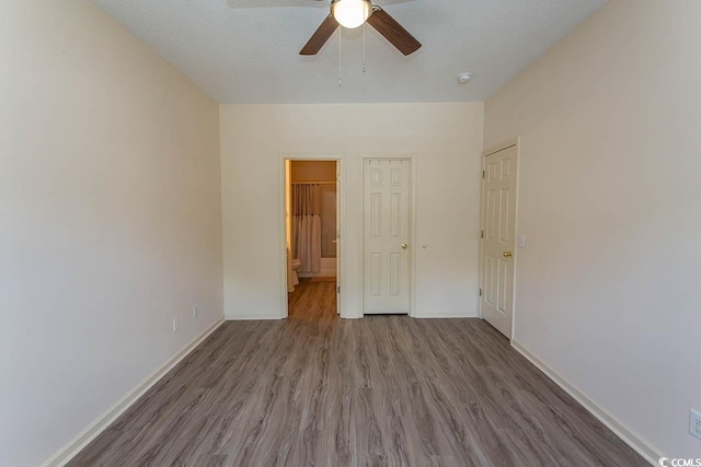 unfurnished bedroom featuring baseboards, ceiling fan, and wood finished floors