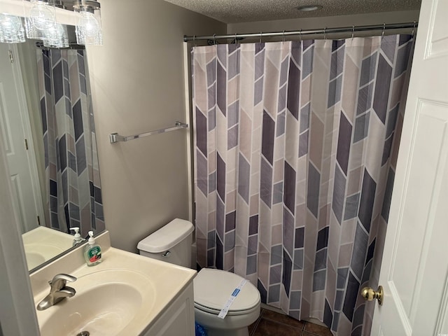 full bathroom featuring vanity, tile patterned floors, a textured ceiling, a shower with curtain, and toilet