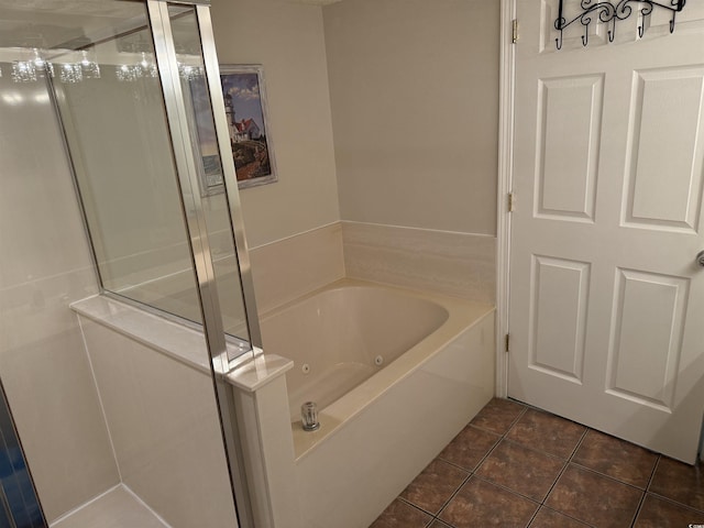bathroom with a whirlpool tub, tile patterned floors, and a stall shower
