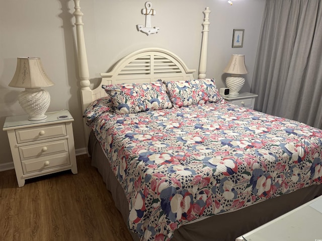 bedroom featuring baseboards and wood finished floors
