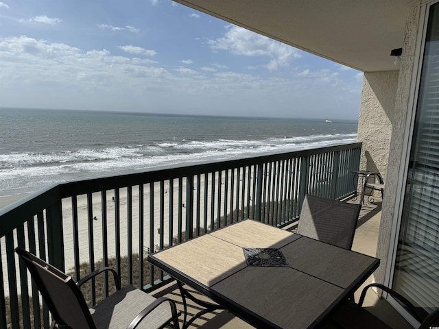 balcony with a view of the beach and a water view