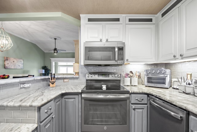 kitchen featuring stainless steel appliances, gray cabinets, and decorative backsplash