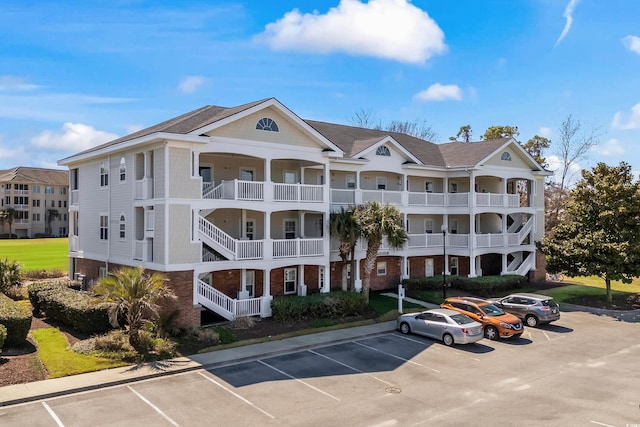 view of apartment building / complex with uncovered parking