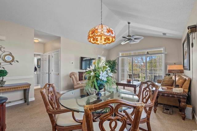 carpeted dining space with vaulted ceiling and ceiling fan