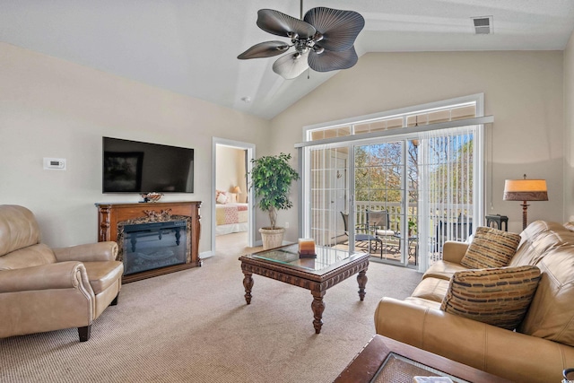 living room featuring a ceiling fan, carpet, a fireplace, and high vaulted ceiling