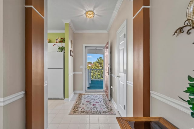 entrance foyer with light tile patterned flooring, ornamental molding, and baseboards