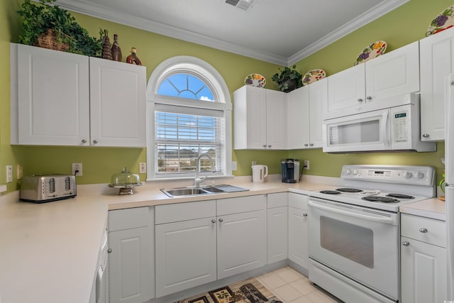 5751 Oyster Catcher Dr Unit 234, North Myrtle Beach, SC 29582 - kitchen featuring white appliances, crown molding, white cabinets, light countertops, and light tile patterned flooring