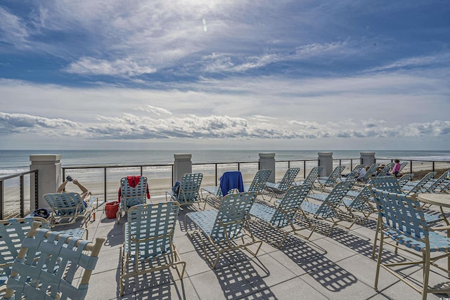 view of patio / terrace with view of water and beach