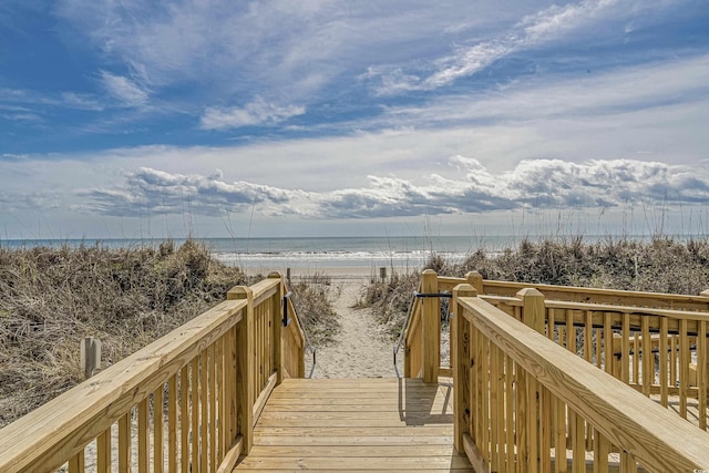 view of property's community with view of water and beach
