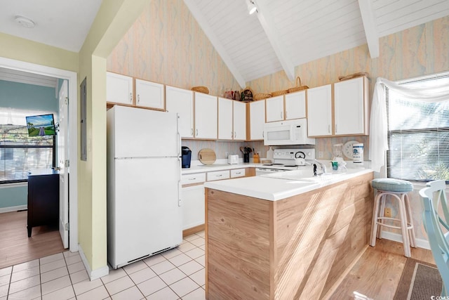 kitchen featuring light tile patterned floors, white appliances, a peninsula, light countertops, and vaulted ceiling with beams