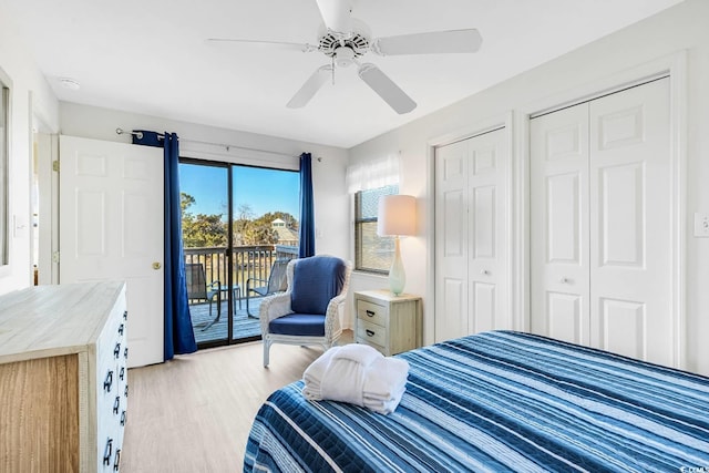 bedroom featuring light wood-style flooring, access to outside, ceiling fan, and multiple closets