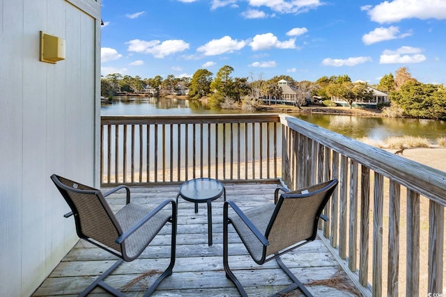 wooden terrace featuring a water view