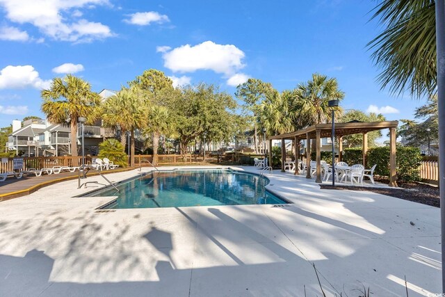 pool featuring a patio area and fence
