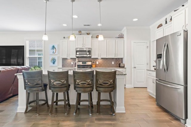 1101 Bronwyn Cir N, Myrtle Beach, SC 29582 - kitchen featuring appliances with stainless steel finishes, open floor plan, decorative backsplash, white cabinetry, and ornamental molding