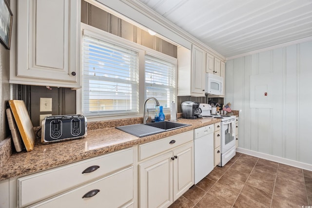 kitchen featuring a sink, white appliances, crown molding, tile patterned flooring, and baseboards