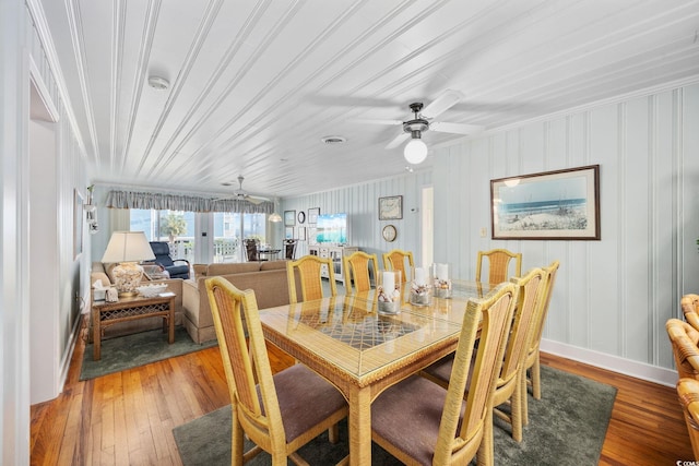 dining space featuring hardwood / wood-style flooring, baseboards, and a ceiling fan