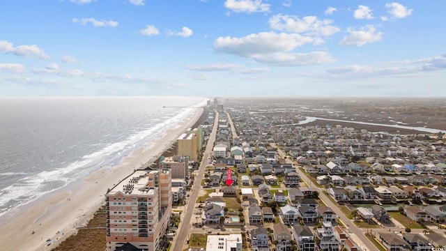 birds eye view of property featuring a beach view and a water view