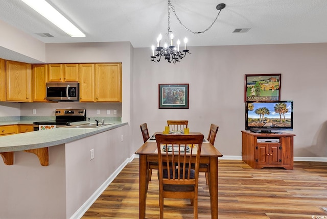 4608 Arran Ct Unit E, Myrtle Beach, SC 29579 - dining room with a chandelier, light wood-style floors, and baseboards