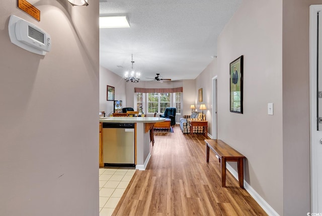 4608 Arran Ct Unit E, Myrtle Beach, SC 29579 - kitchen with stainless steel dishwasher, open floor plan, light wood finished floors, a chandelier, and a textured ceiling