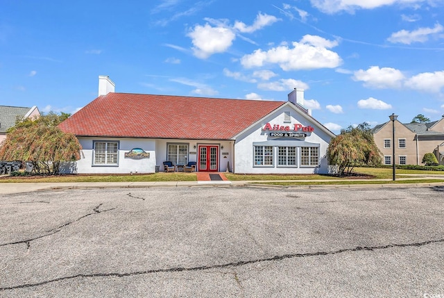 4608 Arran Ct Unit E, Myrtle Beach, SC 29579 - view of front of house with french doors, a chimney, and stucco siding