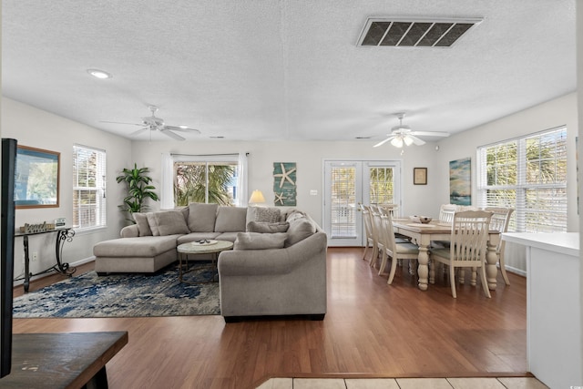 213-A 16th Ave S, Surfside Beach, SC 29575 - living area with a wealth of natural light, ceiling fan, a textured ceiling, and visible vents