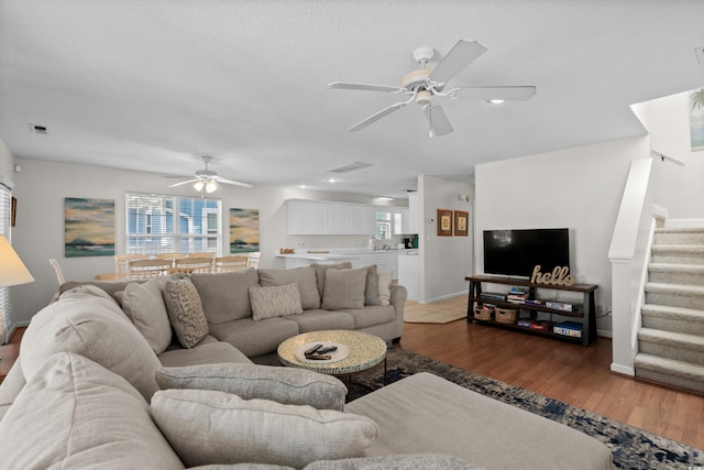 213-A 16th Ave S, Surfside Beach, SC 29575 - living room with visible vents, stairs, wood finished floors, baseboards, and ceiling fan