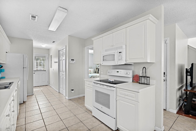 213-A 16th Ave S, Surfside Beach, SC 29575 - kitchen featuring light countertops, white cabinets, white appliances, and light tile patterned flooring