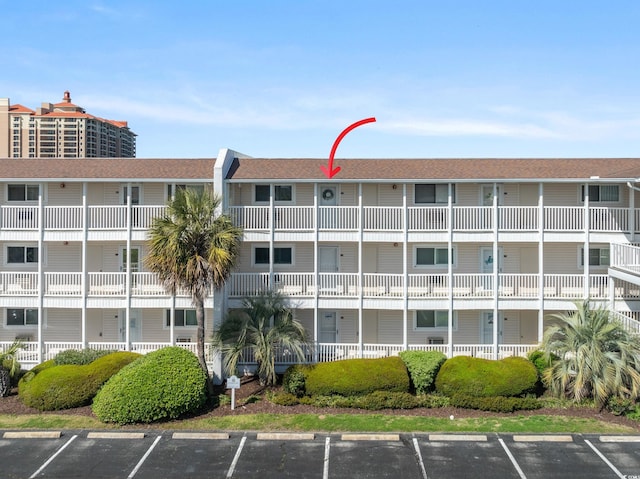 view of property with uncovered parking