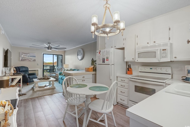 kitchen with ornamental molding, white appliances, light countertops, white cabinetry, and light wood finished floors