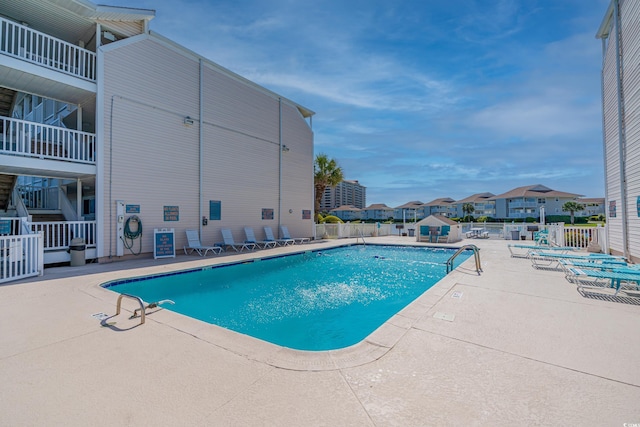 pool featuring a patio and fence