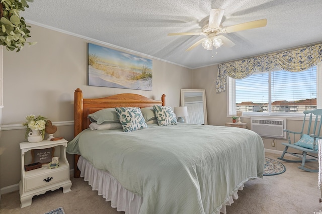 bedroom with ornamental molding, a textured ceiling, carpet floors, a wall unit AC, and ceiling fan