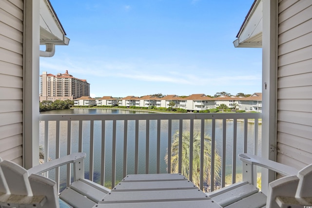 balcony featuring a water view and a residential view