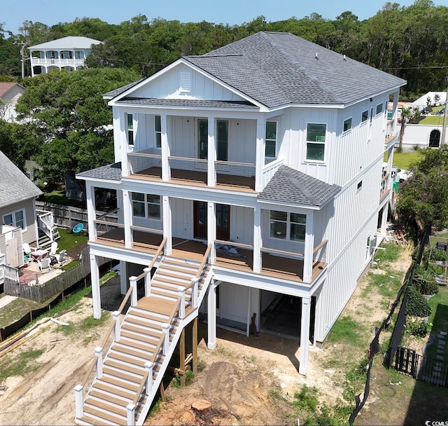 914 Perrin Dr, North Myrtle Beach, SC 29582 - rear view of property featuring roof with shingles, stairway, a balcony, a porch, and board and batten siding