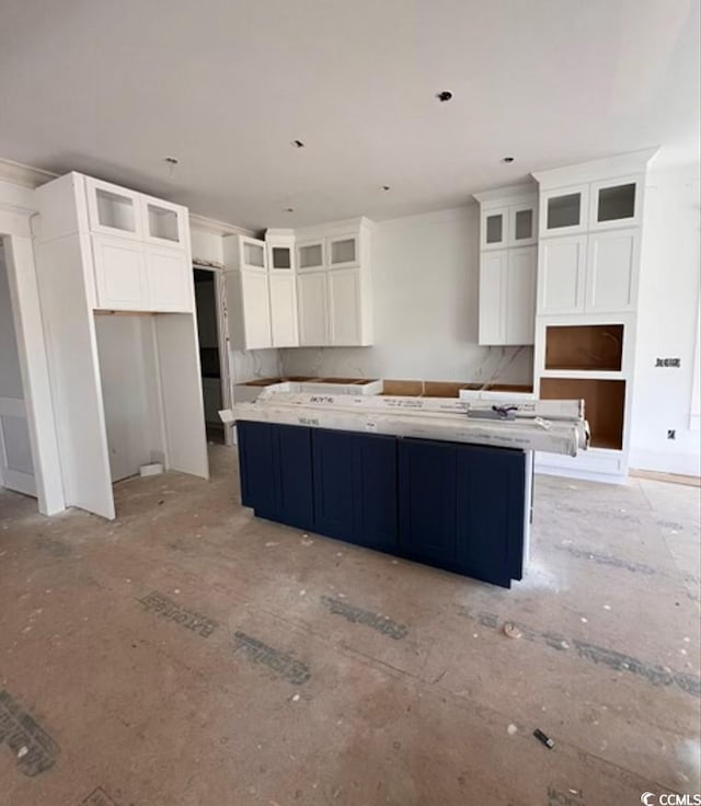 914 Perrin Dr, North Myrtle Beach, SC 29582 - kitchen featuring a large island, white cabinetry, glass insert cabinets, and crown molding