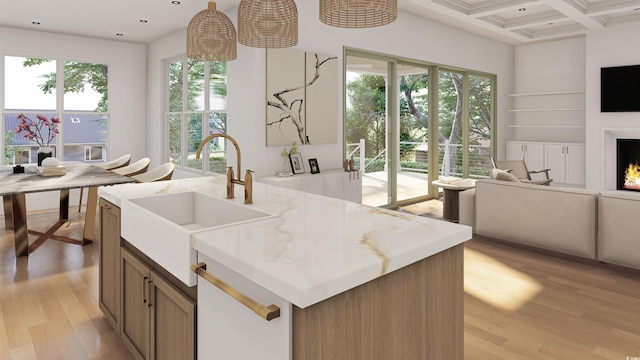 914 Perrin Dr, North Myrtle Beach, SC 29582 - kitchen featuring open floor plan, a sink, light wood-style flooring, beamed ceiling, and coffered ceiling