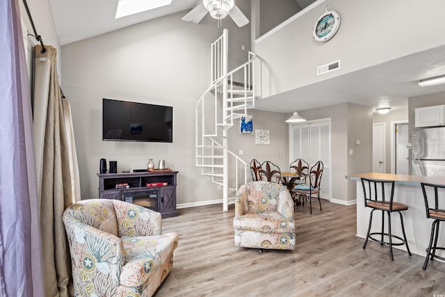1851 Colony Dr Unit 6J, Myrtle Beach, SC 29575 - living room with high vaulted ceiling, stairs, light wood-style flooring, ceiling fan, and baseboards