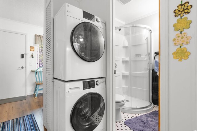 610 Putters Ln Unit H-109, Little River, SC 29566 - washroom featuring laundry area, stacked washer and clothes dryer, and wood finished floors