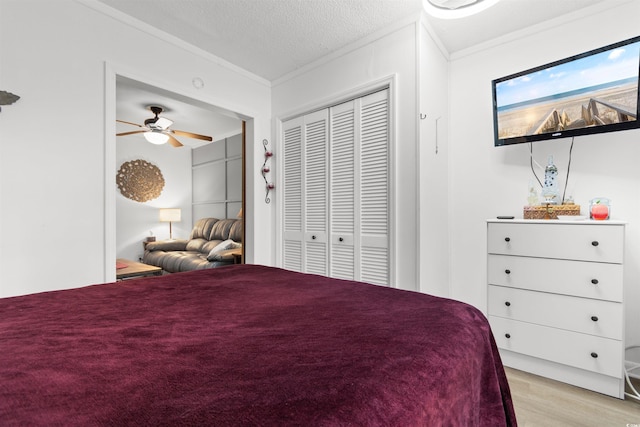 610 Putters Ln Unit H-109, Little River, SC 29566 - bedroom with a closet, a textured ceiling, ornamental molding, and light wood-type flooring