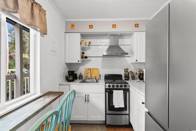610 Putters Ln Unit H-109, Little River, SC 29566 - kitchen with appliances with stainless steel finishes, a sink, wall chimney exhaust hood, white cabinetry, and tasteful backsplash